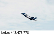 BERLIN - JUNE 06, 2024: Demonstration flight of the Stealth multirole fighter Lockheed Martin F-35 Lightning II. US Air Force. ILA Berlin Air Show 2024. Редакционное фото, фотограф Sergey Kohl / Фотобанк Лори