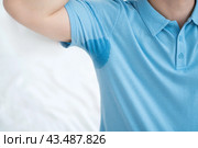 Man in blue polo with sweaty armpits. Стоковое фото, фотограф Станислав Тарко / Фотобанк Лори