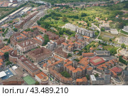 Beautiful landscape of Basque country. Bilbao uptown. Natural green summer background of trees, grass. Small houses broad road on the ground. View through window glass of airplane (2019. Стоковое фото, фотограф YuryKara / Фотобанк Лори
