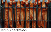 Inmates in Orange Jumpsuits Walking Down a Prison Corridor. Стоковое AI-изображение, AI-художник Юлия Гапеенко / Фотобанк Лори