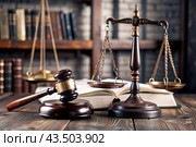 Justice and the law. A wooden hammer, books and scales on the table. The court session. Стоковое AI-изображение, AI-художник Photojuli / Фотобанк Лори