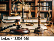 Justice and the law. A wooden hammer, books and scales on the table. The court session. Стоковое AI-изображение, AI-художник Photojuli / Фотобанк Лори