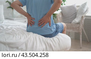 Back pain, kidney inflammation, man suffering from backache at home, health problems concept. Стоковое видео, видеограф Станислав Тарко / Фотобанк Лори