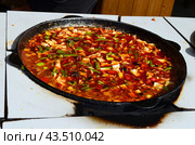 Мясо и овощи, приготовленные в огромном казане на улице. Стоковое фото, фотограф Staryh Luiba / Фотобанк Лори