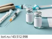 Syringe and glass vial on blue background table. Medical Vials group, needles, ampoules, bottle with medicines or vaccine. Disease treatment. Creative Banner. Anti-aging beauty injections. Vaccination. Стоковое AI-изображение, AI-художник Марина Демидюк / Фотобанк Лори