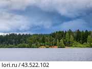 Picturesque lake landscape. There are dark clouds in the sky before the rain. View of the forest on the lake. Стоковое фото, фотограф Андрей Степанов / Фотобанк Лори