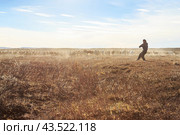 Amguema tundra, Chukotka, Russia - September 7, 2013. Chukchi reindeer herder in a herd of reindeer in the tundra. A man with a lasso catches a deer. Traditional reindeer husbandry in the Arctic. Редакционное фото, фотограф Андрей Степанов / Фотобанк Лори