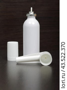Inhaler for the treatment of respiratory organs. Spray can and cap white. On a dark surface. Стоковое фото, фотограф Vadzim Yakubovich / Фотобанк Лори