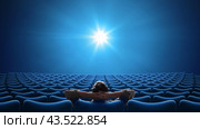 Empty blue cinema with VIP sitting in center and looking on bright screen. Стоковое фото, фотограф Андрей Кузьмин / Фотобанк Лори