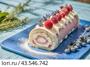 Swiss sponge roll with raspberries, a delicious fruit and cream dessert filled with cream cheese, decorated with fresh raspberries. Стоковое AI-изображение, AI-художник Photojuli / Фотобанк Лори