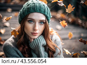 Autumn portrait. Close-up of a red-haired young woman with expressive green eyes in a knitted hat and sweater. Стоковое AI-изображение, AI-художник Photojuli / Фотобанк Лори