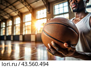 A black basketball player holds a basketball ball against the background of a basketball court. Hands and ball close-up. Стоковое AI-изображение, AI-художник Photojuli / Фотобанк Лори