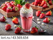 Refreshing strawberry milkshake with whipped cream and a straw on the table surrounded by fresh strawberries. Стоковое AI-изображение, AI-художник Photojuli / Фотобанк Лори