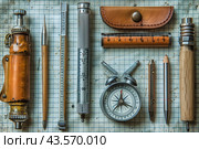 Vintage Drafting Tools Arranged on Gridded Paper. Стоковое AI-изображение, AI-художник Сергей Толмачёв / Фотобанк Лори