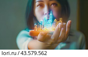 A woman holds a holographic cityscape model in her palm. Стоковое AI-видео, аниматор Данила Большаков / Фотобанк Лори