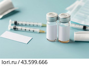 Syringe and glass vial on blue background table. Medical Vials group, needles, ampoules, bottle with medicines or vaccine. Disease treatment. Creative Banner. Anti-aging beauty injections. Vaccination. Стоковое AI-изображение, AI-художник Марина Демидюк / Фотобанк Лори