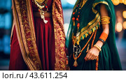 Two women in traditional Indian attire, showcasing colorful saris and intricate jewelry, standing side by side. Стоковое AI-изображение, AI-художник Tatiana Syrtseva / Фотобанк Лори