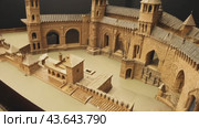 A person is deeply involved in the activity of playing with a small cardboard castle. Стоковое AI-видео, аниматор Юрий Поздников / Фотобанк Лори