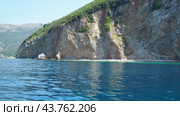 RT Dubovica Rocks near Buljarica and Svetac Rock, Montenegro. Stones, inaccessible rocks. Flysch marine lithological layers. Adriatic Mediterranean sea blue water. Nature park Katici. District Budva. Стоковое видео, видеограф Юлия Петровская / Фотобанк Лори