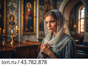 Portrait of a beautiful young woman in a headscarf in an Orthodox church. A girl prays in a church against the background of icons. Стоковое AI-изображение, AI-художник Photojuli / Фотобанк Лори