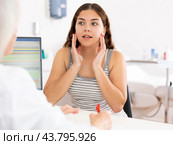 Young woman patient discussing face aesthetic procedures with a specialist. Стоковое фото, фотограф Яков Филимонов / Фотобанк Лори