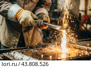 Work at the factory. Working professions. Men's hands in protective gloves with metal. There are sparks around. Hard work that requires high concentration and professionalism. Стоковое AI-изображение, AI-художник Photojuli / Фотобанк Лори