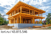 A wooden house is currently in the process of being constructed in a wide open field. Стоковое AI-изображение, AI-художник Юрий Поздников / Фотобанк Лори
