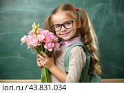 A sweet, beautiful first-grader girl with glasses. In the hands of a bouquet of flowers. The child goes to school for the first time. A child with a backpack, a book and flowers. Back to school. Стоковое AI-изображение, AI-художник Photojuli / Фотобанк Лори