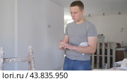 Portrait of teenage boy holding bunch of earned money for part-time work in construction site. Стоковое видео, видеограф Яков Филимонов / Фотобанк Лори