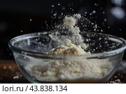 Sifting flour in a glass bowl. Стоковое AI-изображение, AI-художник Иван Рябоконь / Фотобанк Лори