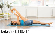 Young woman practicing vinyasa yoga in studio. Стоковое фото, фотограф Яков Филимонов / Фотобанк Лори