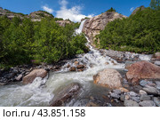 View of the Alibek waterfall formed by the fall of the Jalovchatka River from the Alibek glacier on a sunny summer day, Dombay, Karachay-Cherkessia, Russia. Стоковое фото, фотограф Ula Ulachka / Фотобанк Лори