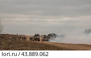 Солдаты и военная техника на пустынной земляной дороге. Танк, бтр, рсзо движутся на позицию. Армия России. (2019 год). Редакционное фото, фотограф Евгений Зимин / Фотобанк Лори