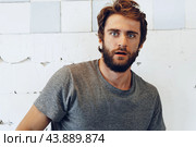 Expressive young bearded man scared and nervous. Стоковое фото, фотограф Сергей Толмачёв / Фотобанк Лори
