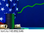Price of american oil is changing concept. Black barrel with oil and graph. Стоковое фото, фотограф Сергей Толмачёв / Фотобанк Лори
