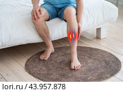 Fibula fracture, broken leg, man suffering from pain, accident at home. Стоковое фото, фотограф Станислав Тарко / Фотобанк Лори