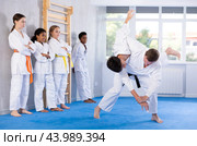 Jiu-jitsu coach demonstrating throws in training bout with teenager. Стоковое фото, фотограф Яков Филимонов / Фотобанк Лори