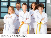 Group of preteen children karate fighters with arms crossed. Стоковое фото, фотограф Яков Филимонов / Фотобанк Лори