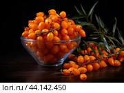 Fresh sea buckthorn berries in glass bowl. Стоковое AI-изображение, AI-художник Иван Рябоконь / Фотобанк Лори