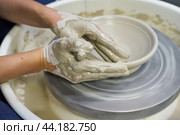 Woman making ceramic pottery on wheel, hands closeup. Concept for woman in freelance. Стоковое фото, фотограф Natalia Gdovskaia / Фотобанк Лори
