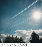 Chemtrail conspiracy theory. Long-lasting condensation trails left in sky by high-flying aircraft are actually chemtrails consisting of chemical or biological agents, sprayed for nefarious purposes. Стоковое AI-изображение, AI-художник Юлия Петровская / Фотобанк Лори