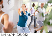 Senior woman and man enjoying boogie-woogie in dance studio. Стоковое фото, фотограф Яков Филимонов / Фотобанк Лори