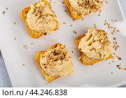 Four hummus sandwiches are laid out on plate - traditional snack of Middle East. Стоковое фото, фотограф Яков Филимонов / Фотобанк Лори