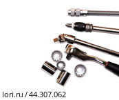 Screwdriver with interchangeable bits and a rigid and flexible metal extension cord, ratchet wrench. Стоковое фото, фотограф Дмитрий Львович Алферов / Фотобанк Лори