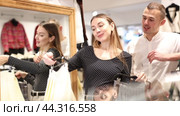 Couple young woman and young man choosing skirt. Стоковое видео, видеограф Яков Филимонов / Фотобанк Лори