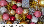 Christmas Ornaments Background Rotation, Spinning. Close up a Glitter Christmas Tree Decoration Items is Turning. Backdrop of New Year Ornate. Many Shiny Xmas Bauble, Balls and Bulbs. Top View, Frame. Стоковое видео, видеограф Марина Демидюк / Фотобанк Лори