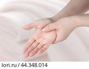Closeup of female arms holding his painful wrist . Woman massaging painful wrist at work repetitive strain injury. Carpal tunnel syndrome, arthritis, neurological disease concept. Стоковое фото, фотограф Павел Муравьев / Фотобанк Лори