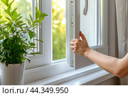 New plastic PVC window with white metal frame installed at modern house, view of blurred green trees, blue sky. Advertising. Typical installation of insulated glazing windows with uPVC window frames. Стоковое AI-изображение, AI-художник Марина Демидюк / Фотобанк Лори