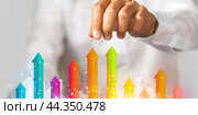 Increased profits. Benchmarking. Businessman analyzes profitability of working companies with digital augmented reality graphics, positive indicators, growing up graph and charts, colorful arrows. Стоковое AI-изображение, AI-художник Марина Демидюк / Фотобанк Лори