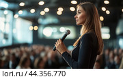 A woman delivers a keynote speech at a corporate conference in a well-lit auditorium filled with engaged audience members. Стоковое AI-изображение, AI-художник Сергей Толмачёв / Фотобанк Лори